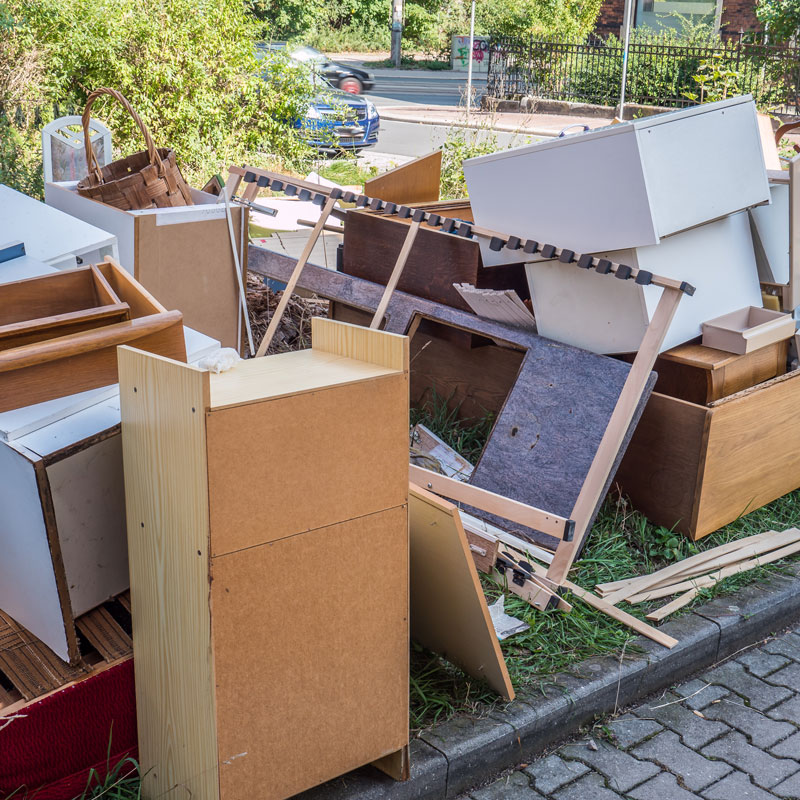 pile of junk and old furniture piled outside home for pickup